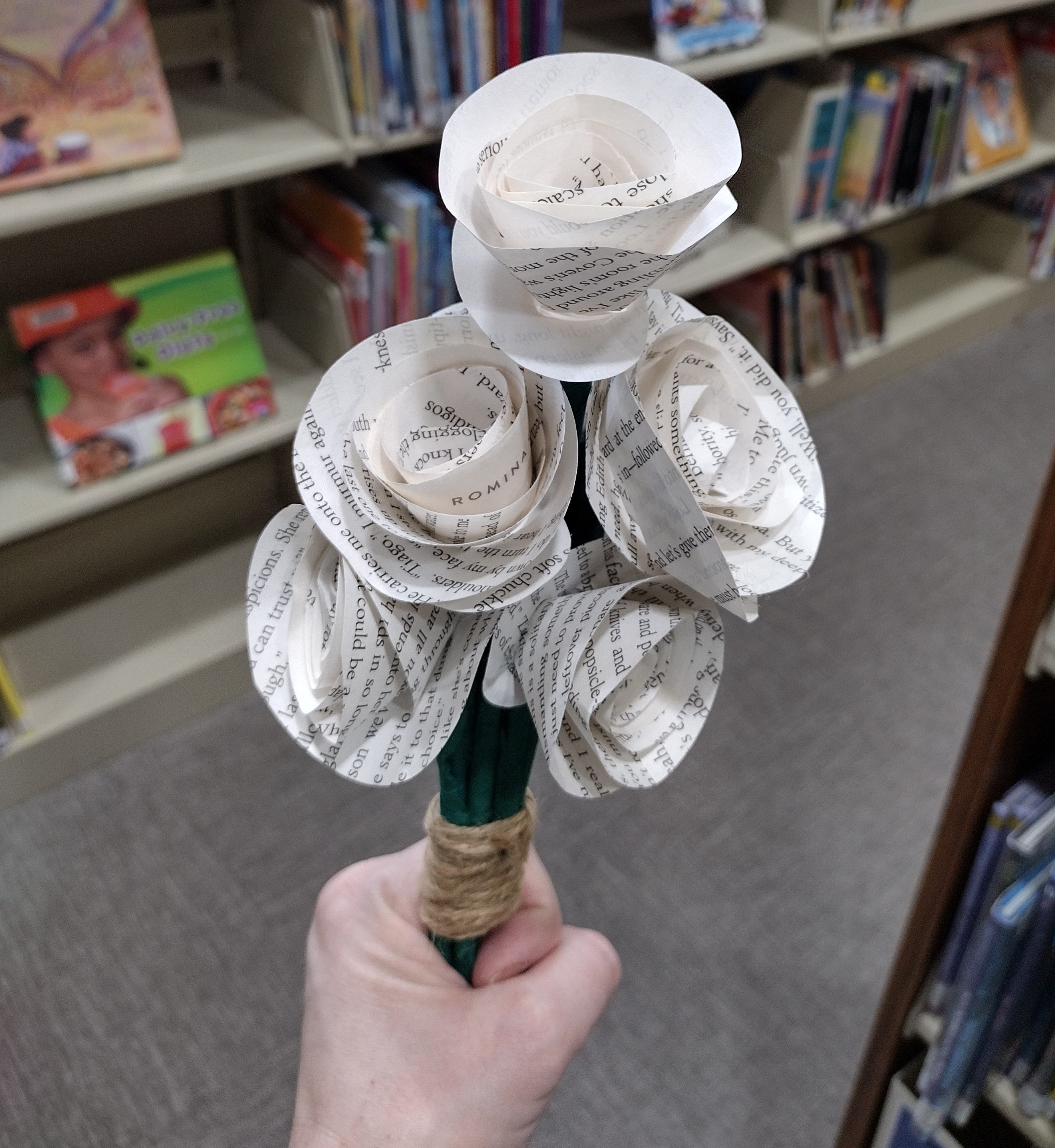 DIY folded paper roses made from repurposed book pages. 