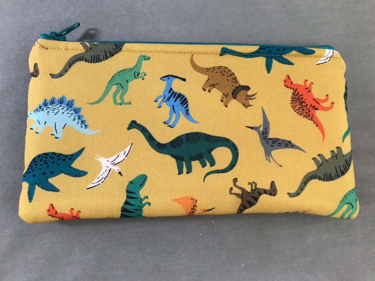 zip top pencil bag made of dinosaur print fabric
